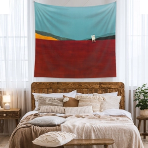 Bedroom wall with bohemian tapestry showing a rider on a white horse in desert