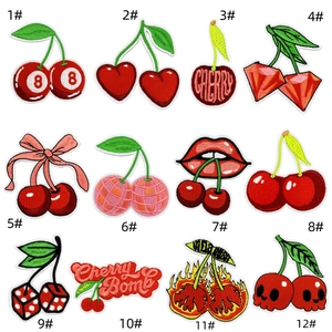 Close-up of 12 assorted cherry-themed embroidery patches with sequins and diverse patterns