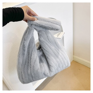 Detail of grey plush faux fur tote bag with vertical stripes and soft fuzzy texture