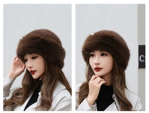 Close-up of thick dark brown faux fur texture and brim detail on a winter beret hat