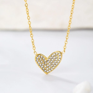 Macro shot of gold-plated stainless steel heart pendant with sparkling micro-pave zircons