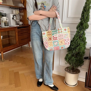Quilted tote bag detail on model in warm vintage indoor setting for stylish daily commute