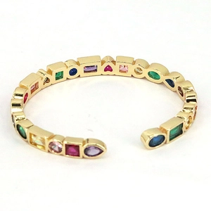 Gold open bangle featuring multi-shaped colorful zircon stones in Bohemian style