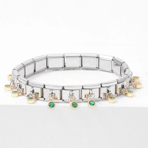 Detail of silver modular stainless steel link bracelet with gold-tone green gem charms
