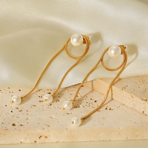 Elegant gold stainless steel snake chain tassel earrings with pearls on beige stone base