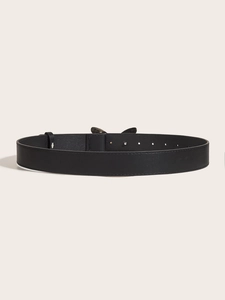 Detailed view of a black leather belt with a butterfly rhinestone buckle and metal finish