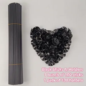 Set of 100 black plastic balloon sticks and cup holders arranged in a heart shape
