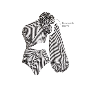 Detail of one-shoulder swimsuit with 3D flower and removable black white striped sleeve