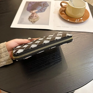 Long zipper wallet with black, white, and brown geometric patterns and gold zipper detail