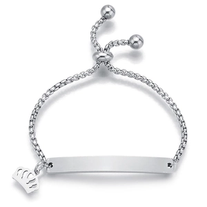 Close-up of adjustable silver box chain bracelet with engravable plate and crown charm