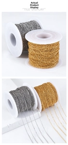 Macro view of gold and silver plated stainless steel chains on white spools for DIY jewelry