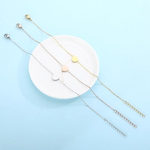 Detailed view of minimalist heart pendants on thin chains in gold, rose gold and silver