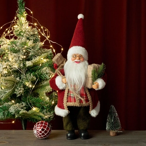 Close-up of 12-inch Santa Claus figurine with red velvet suit and gift bag decor