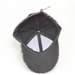 Detail view of ethnic woven baseball cap featuring adjustable brown leather strap and buckle