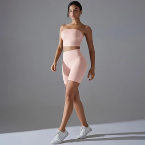Detail of pink two-piece yoga set featuring seamless bandeau top and high waist booty shorts