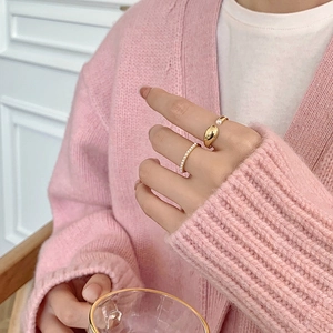 Close-up of gold plated pearl rings set on a hand for a minimal and elegant look