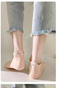 Close-up of low-cut ankle socks with cute rabbit ear design and cartoon embroidery