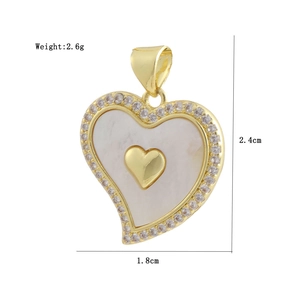 Macro view of a gold heart pendant with white shell inlay and zircon border with dimensions