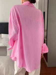 Back view of a pink striped casual shirt showing a relaxed fit and quality fabric texture