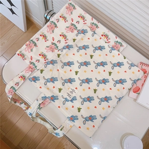 Detail of cute rabbit print cotton tote bags with stylish fabric labels on white surface
