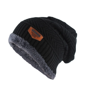 Detail view of winter knit beanie with soft grey fleece lining and leather brand patch
