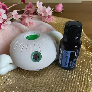 Close-up of a white sphere essential oil diffuser with dōTERRA peppermint oil set