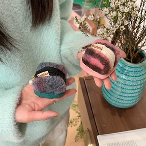 Detail of plush macaron-shaped protective case for AirPods with pearl keychain