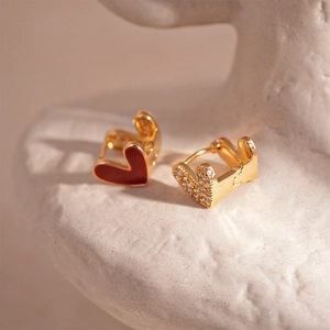 Detailed view of dual-sided heart hoop earrings with red enamel and pavé white zircon