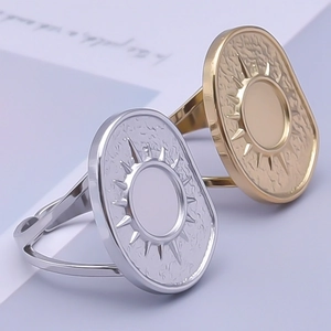Macro detail of sun totem engraved rings in gold and silver with adjustable bands