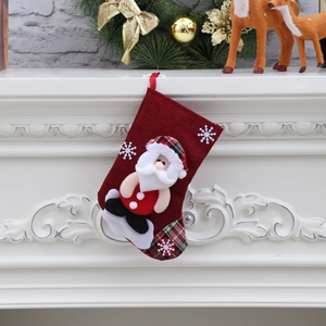 Detail of red Christmas stocking with 3D Santa Claus and snowflake embroidery