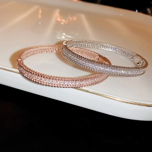 Close-up of luxury zircon bracelets in rose gold and silver with beaded edges