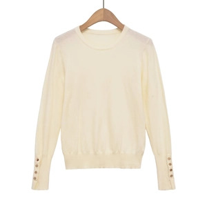 Chic cream slim fit knit sweater with golden decorative buttons on the long sleeve cuffs