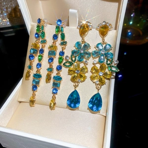 Macro detail of luxury dangling earrings with multi-colored crystals in a jewelry box