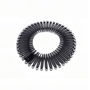 Detail of circular stretch hair comb with sparkling crystals on black resin base