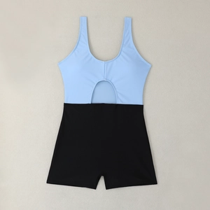 Detail of blue one-piece swimsuit featuring black boyshorts and stomach cutout design