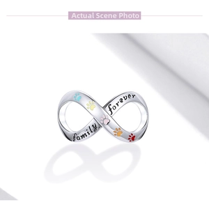 Detail of infinity charm with family forever engraving and colorful pet paw prints