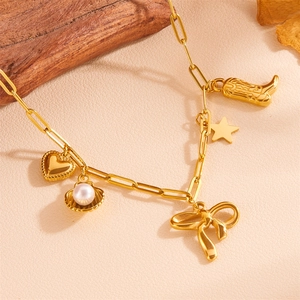 Detailed view of gold stainless steel necklace with shell, heart, and star charms
