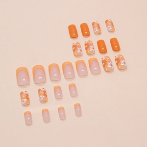 24 faux ongles orange avec motifs de marguerites et design de manucure française