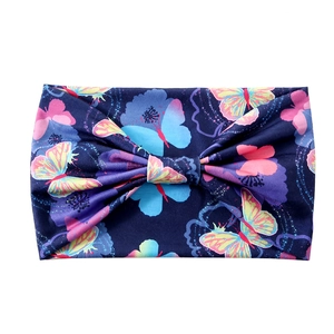 Elastic wide headband for women featuring navy blue fabric with colorful butterfly prints