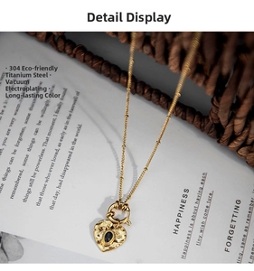 Detailed close-up of 18K gold plated heart pendant with black stone and hammered texture