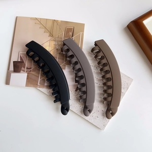 Three large matte banana hair clips in black, dark grey, and brown colors for thick hair