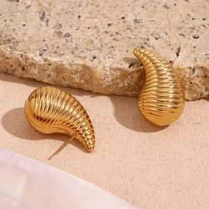 Macro shot of minimalist 18K gold plated teardrop earrings with elegant ribbed texture