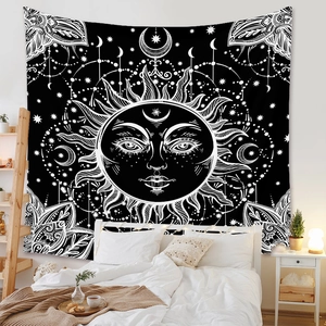 Celestial bohemian wall tapestry with sun and moon pattern in a cozy bedroom setting