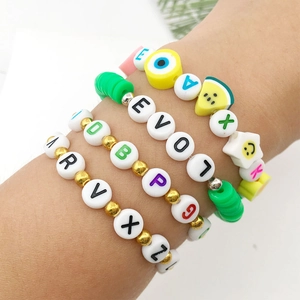 Colorful acrylic alphabet beads and fruit charms on handmade stretch bracelets