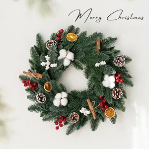 Christmas wreath with pine cones cotton and berries for festive front door decoration