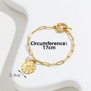 Detail of vintage gold bracelet with crown heart pendant and OT clasp measurement