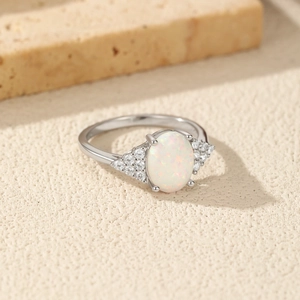 Elegant S925 sterling silver ring with oval opal stone and side diamonds on beige stone