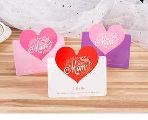 Three Mother's Day cards with pink heart design and Thank You Mom text on wood surface
