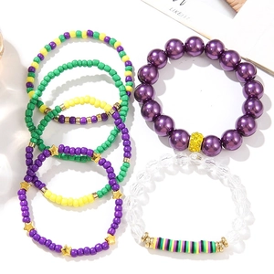 Detail of Bohemian beaded bracelet set with gold star charms and colorful clay beads