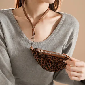Leopard print crossbody mini coin purse necklace with brown leather strap on gray sweater
